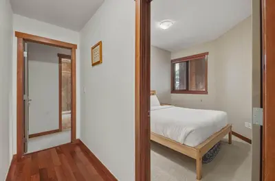 a bedroom with a bed and a mirror at Beautiful Peak Vista - 2BR w Stunning Mt Views in Canmore