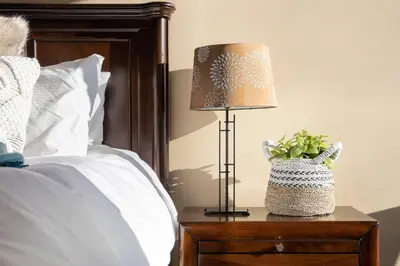 a lamp on a night stand next to a bed at Mountain View Penthouse- 2BR Oasis at the Marquise in Whistler in Whistler