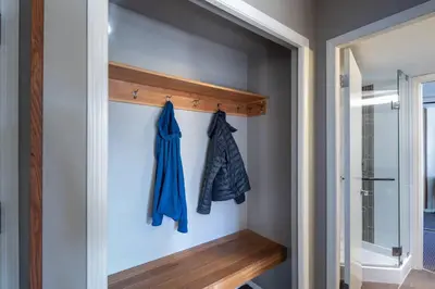 a walk in closet with a blue robe on a wall at Mountain View Penthouse- 2BR Oasis at the Marquise in Whistler in Whistler