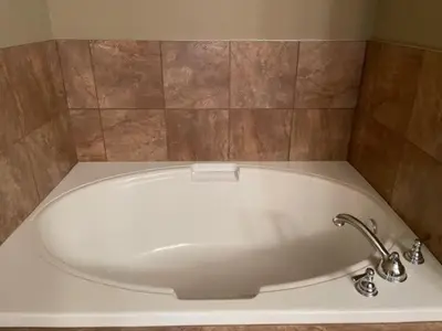 a bath tub with a faucet in a bathroom at Rundle Rise - Spacious Condo Steps from Main Street in Canmore
