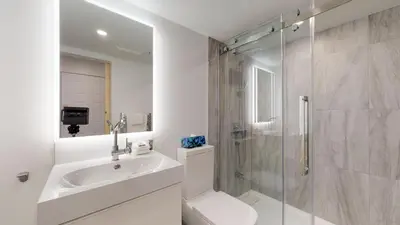 a bathroom with a toilet and a sink and a shower at 1BR and Sofabed at Whistler on the Lake, Lakefront, Serene Setting, Wood Burning Fireplace in Whistler