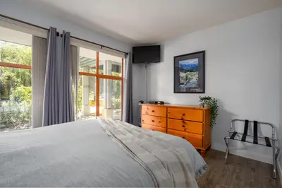 a bedroom with a bed and a dresser and a window at 1BR in Northstar, Village Location, Gas Fireplace, Shared Hot Tub, Ski Storage in Whistler