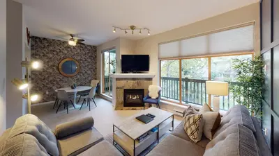 a living room with a couch and a table at 2BR in Northstar, Whistler Village, Fireplace, Hot Tub, Central Location, Ski Storage in Whistler
