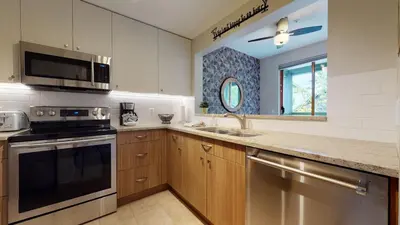 a kitchen with a stove microwave and a sink at 2BR in Northstar, Whistler Village, Fireplace, Hot Tub, Central Location, Ski Storage in Whistler