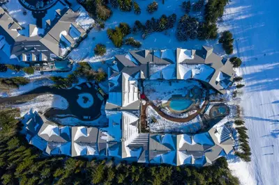 an aerial view of a resort with a swimming pool at 2BR in The Aspens, Ski In, Ski Out, Pool and Hot Tub, Gas Fireplace, Ski Valet, Gym in Whistler