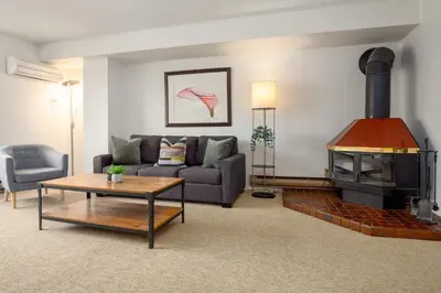 a living room with a couch and a fireplace at 1BR in Carleton Lodge, Unbeatable Mountain Base Location, Ski In, Ski Out, Free Parking in Whistler