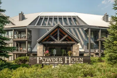 a hotel sign in front of a building at 2BR in Powderhorn, Near Blackcomb, Double-Sided Fireplace, Rooftop Hot Tub, Parking in Whistler
