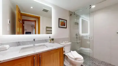 a bathroom with a sink and a toilet and a shower at 2BR in Blackcomb Greens, Wood Burning Fireplace, Communal Hot Tub, Nature Views in Whistler