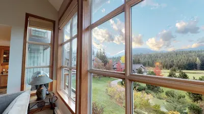a room with a large window with a view at 3BR in Blackcomb Greens, Wood Burning Fireplace, Complex Hot Tub, Parking, Mountain Views in Whistler