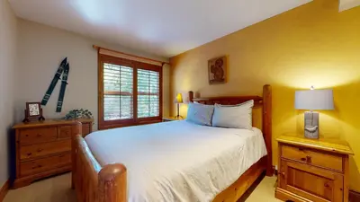 a bedroom with a large bed and a window at 3BR in Blackcomb Greens, Wood Burning Fireplace, Complex Hot Tub, Parking, Mountain Views in Whistler