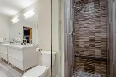 a bathroom with a toilet and a sink and a shower at Luxury Mountain Retreat with PRIVATE Hot Tub by Harmony Whistler in Whistler