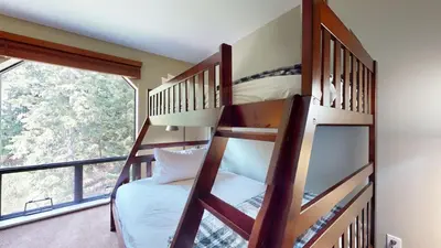 a bedroom with two bunk beds and a large window at 2BR in Ironwood, Fireplace, Common Area Hot Tub, Private Patio, Parking in Whistler