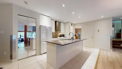 a kitchen with white walls and a large counter top at 2BR in Ironwood, Fireplace, Common Area Hot Tub, Private Patio, Parking in Whistler