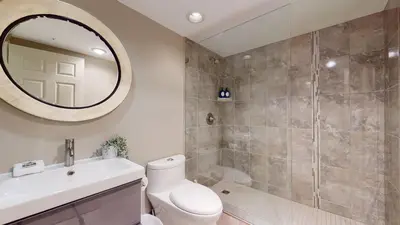 a bathroom with a shower and a toilet and a sink at 2BR in Ironwood, Fireplace, Common Area Hot Tub, Private Patio, Parking in Whistler