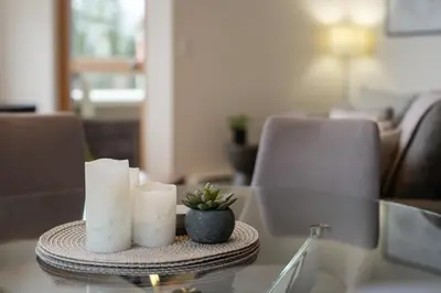 a table with two candles and a plant on it at 3BR in Tyndall Stone Lodge, Village Location with Olympic Plaza Views, Fireplace, Hot Tub in Whistler