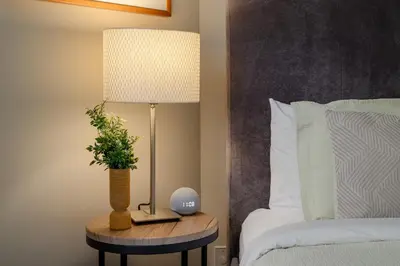 a lamp on a table next to a bed at 3BR in Tyndall Stone Lodge, Village Location with Olympic Plaza Views, Fireplace, Hot Tub in Whistler