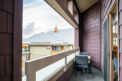 a balcony with a view of a building at 3BR in Tyndall Stone Lodge, Village Location with Olympic Plaza Views, Fireplace, Hot Tub in Whistler