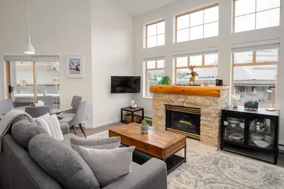 a living room with a couch and a fireplace at 3BR in Tyndall Stone Lodge, Village Location with Olympic Plaza Views, Fireplace, Hot Tub in Whistler