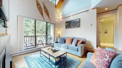 a living room with a couch and a table at 2BR plus Den in The Gables, Unbeatable Location Near Gondolas, Private Balcony, Secure Parking in Whistler