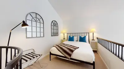 a bedroom with a bed with blue pillows at 1BR plus Loft in Tyndall Stone Lodge, Village Location, Pool and Hot Tub, Private Balcony in Whistler