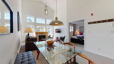 a living room with a glass table and a couch at 1BR plus Loft in Tyndall Stone Lodge, Village Location, Pool and Hot Tub, Private Balcony in Whistler
