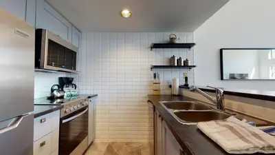 a kitchen with a sink and a counter top at 1BR plus Loft in Tyndall Stone Lodge, Village Location, Pool and Hot Tub, Private Balcony in Whistler