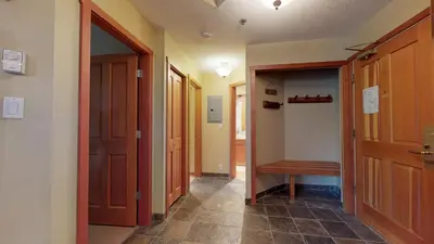 a hallway with two doors and a walk in closet at 3BR in Greystone Lodge, Ski In, Ski Out, Pool and Hot Tub, Epic Location in Whistler