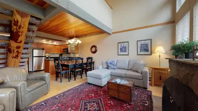 a living room with a couch and a table at 3BR in Greystone Lodge, Ski In, Ski Out, Pool and Hot Tub, Epic Location in Whistler
