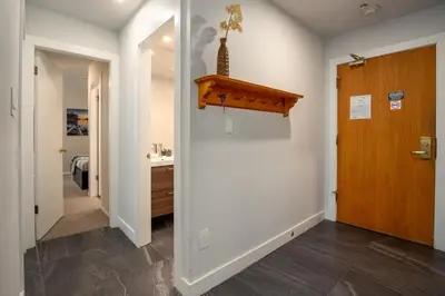 a hallway with a door leading to a bathroom at 2BR plus Loft in Wildwood Lodge, Free Ski Bus, Hot Tub and Pool, Private Patio, Parking in Whistler
