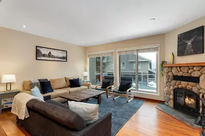 a living room with a couch and a fireplace at 4BR in Blueberry Hill Estates, Lake View, Tranquil Setting, Gourmet Kitchen, Family Sized in Whistler