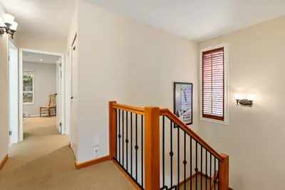 a staircase in a home with white walls at 4BR in Blueberry Hill Estates, Lake View, Tranquil Setting, Gourmet Kitchen, Family Sized in Whistler