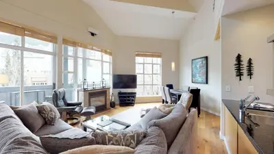 a living room with a couch and a fireplace at 1BR plus Loft in Glacier Lodge, King Bed, Near Gondola, Private Balcony, Free Ski Valet in Whistler