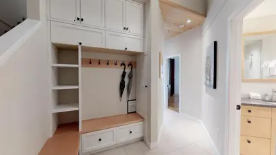 a kitchen with white cabinets and a walk in closet at 1BR plus Loft in Glacier Lodge, King Bed, Near Gondola, Private Balcony, Free Ski Valet in Whistler