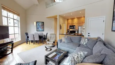a living room with a couch and a dining room at 1BR plus Loft in Glacier Lodge, King Bed, Near Gondola, Private Balcony, Free Ski Valet in Whistler