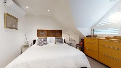 a bedroom with a large white bed and a window at 2BR in The Gables, Steps to Gondolas, Heated Floors, Private Balcony, Fireplace in Whistler