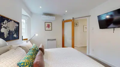 a person sitting on a bed with their feet up on the bed at 2BR in The Gables, Steps to Gondolas, Heated Floors, Private Balcony, Fireplace in Whistler