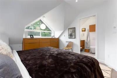 a bedroom with a large bed and a window at 2BR in The Gables, Steps to Gondolas, Heated Floors, Private Balcony, Fireplace in Whistler