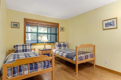 a bedroom with two bunk beds and a window at 3BR in The Woods, Private Hot Tub, Wood Burning Fireplace, King Ensuite, Private Garage in Whistler