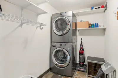 a washer and dryer in a laundry room at 3BR in The Woods, Private Hot Tub, Wood Burning Fireplace, King Ensuite, Private Garage in Whistler