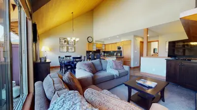 a living room with two couches and a kitchen at 3BR in Montbello, Cozy Townhouse, Private Hot Tub, Near Village, Fireplace in Whistler