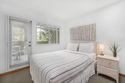 a white bedroom with a bed and a window at 3BR in Lagoons, King Bed, Private Balcony, Village Location, Parking in Whistler