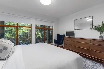 a bedroom with a bed and a dresser and a tv at 1BR in Northstar, Village Location, Shared Pool and Hot Tub, Ski Storage, Free Parking in Whistler