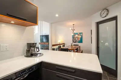 a kitchen with a counter top with a coffee maker at 2BR plus Den in The Gables, Dog Friendly, Near Both Mountains, Wood Burning Fireplace, Free Parking in Whistler