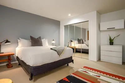 a bedroom with a bed and a large mirror at 2BR plus Den in The Gables, Dog Friendly, Near Both Mountains, Wood Burning Fireplace, Free Parking in Whistler