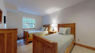 a bedroom with two beds and a window at 3BR in Alpine Greens, Ski Storage, Wood Burning Fireplace, Free Ski Shuttle in Whistler