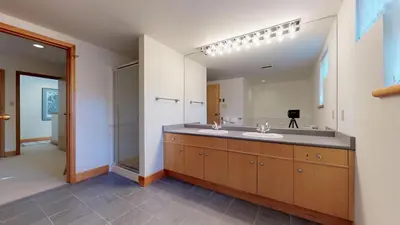 a bathroom with a sink and a large mirror at 3BR in Alpine Greens, Ski Storage, Wood Burning Fireplace, Free Ski Shuttle in Whistler