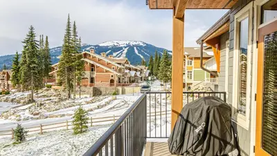 a balcony with a view of a snow covered mountain at Echo Landing #05 by Bear Country in Sun Peaks