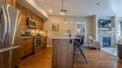 a kitchen with a stainless steel refrigerator and a counter at Echo Landing #05 by Bear Country in Sun Peaks