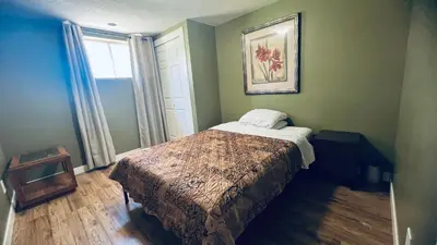 a bedroom with a bed in a room with a window at Private Rooms in a 3 Bedroom Guest House Close to Kingsway NAIT 1 Person per Room No Couples For Men Only in Edmonton