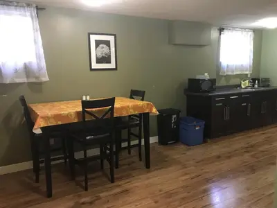 a dining room with a table and some chairs at Private Rooms in a 3 Bedroom Guest House Close to Kingsway NAIT 1 Person per Room No Couples For Men Only in Edmonton